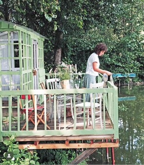 Relax on the deck overlooking the serene water.