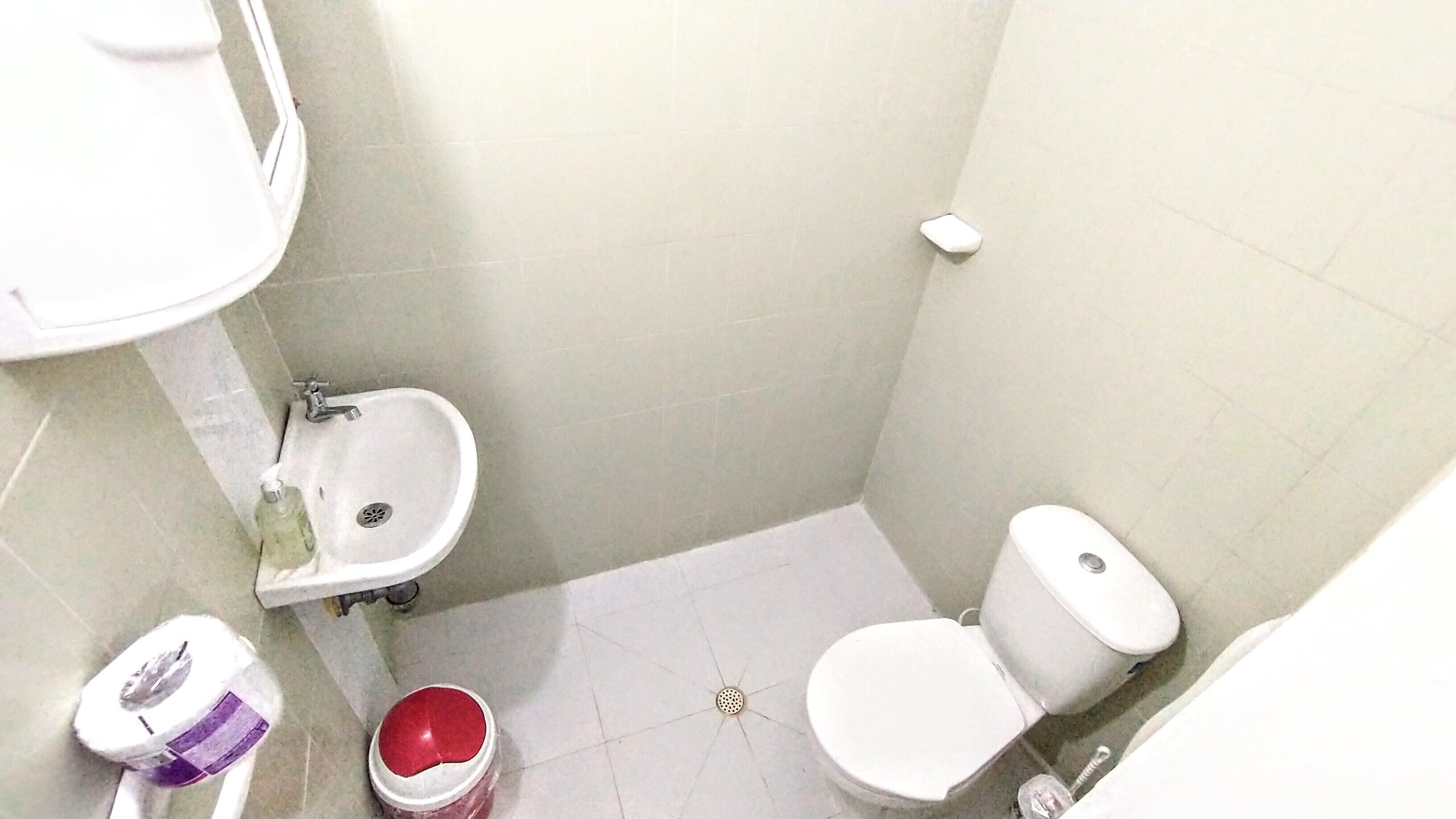 A small bathroom with a toilet, bidet, and sink.