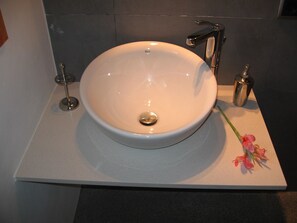 A white bathroom sink with a single faucet and a small bottle of soap on the right. - Villa With Private Pool, Sauna And Jacuzzi (Pollença)