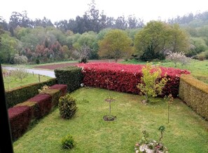 Stroll through the beautifully manicured garden, surrounded by lush greenery and a tranquil body of water.