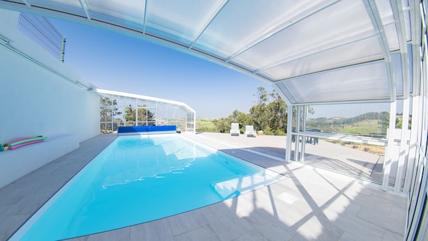 An indoor swimming pool with a clear view of the surrounding landscape. - Ribamar-Quinta Mar and Terra Villas (Ribamar)