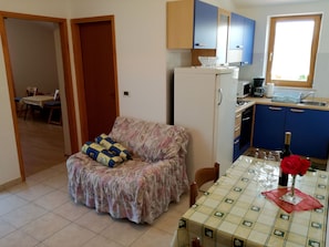 Cozy living space with a kitchenette, dining area, and comfortable seating.