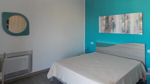A bedroom with a bed, a wall-mounted mirror, a radiator, and a ceiling light fixture. - Apartment "Full Moon" (Tusa)
