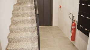 A staircase with a handrail leading to an elevator. - Apartment very central and very well connected. (Albacete)