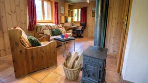 A cozy wooden cabin with a fireplace, a sofa, and a dining table. - Chalet Cuckoo, Romantic Alpine Getaway. Val d'Anniviers, Valais, Switzerland (Ayer)