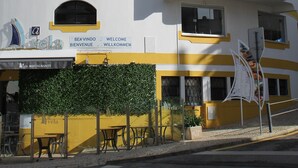 A white building with yellow trim and multiple balconies.