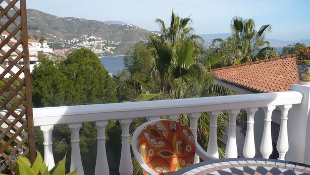 A balcony with a white balustrade, a patterned cushion, and a tiled floor. - chalet bougainvillea sea view 500 m. from the beach available wifi (Almuñécar)