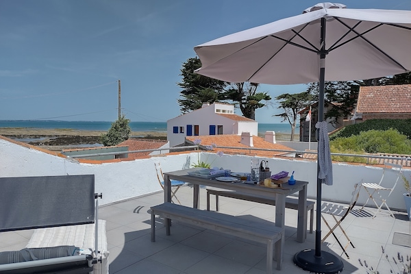 Terrace with umbrellas and sun loungers. Private beach without the sand!