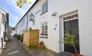 Stroll through this charming alleyway lined with traditional buildings and lush greenery.