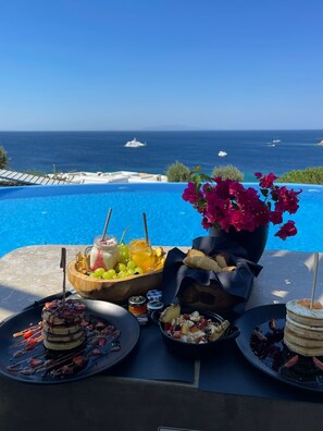 An infinity pool, sun loungers