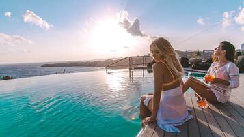 An infinity pool, sun loungers