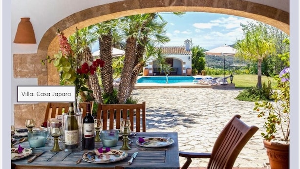 A table set for dining with a view of a pool and villa in the background. - Five stars reviews - Peaceful - Fantastic pool - Privacy & Long views (Jávea)