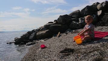 Children can enjoy beach activities on this scenic shoreline.