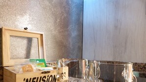 A wooden box labeled "infusion" on a granite countertop, containing items and two clear glasses.