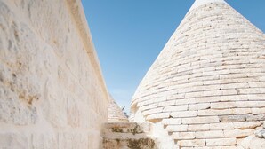 A stone staircase leading up to a conical roof structure.