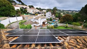 Solar panels on a rooftop with a view of a residential area in the background. - Fantastic House with Private Pool in Lloret de Mar (Vidreres)