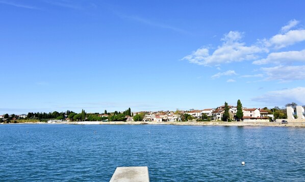 A waterfront view with buildings and a clear sky.