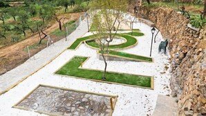 A landscaped garden with geometric pathways, a central tree, and a stone feature. - Rural house (rental entire) Reul Alto Cortijos Rurales for 2 people (Laroya)