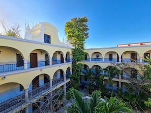 A multi-story building with arched balconies and a central courtyard. - Hotel Fundadores (Valladolid)