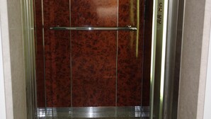 An elevator with a metallic interior and a brown wall. - Luxury Aptmt, Seaview Sunset, Large Pool, free Wi-Fi, UK-TV (Peyia)