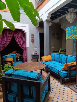 An outdoor seating area with a sofa and chairs, a table, and a decorative lantern. - Riad 'Dar Marly'  Just for you ,and your family..We love it! (Marrakech)