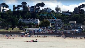 A beach with houses in the background.
