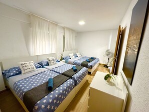 A bedroom with two beds, each with star-patterned bedding and pillows with motivational phrases. - Boutique Apartment by the Sea (Alicante)