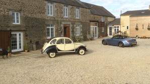 A stone building with a gravel driveway.