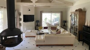 A living room with a fireplace, sofa, coffee table, and a piano. - Exceptional villa in Provence's Luberon region with a pool and breathtaking views (CAVAILLON)