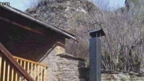 A stone building with a wooden staircase and a chimney. - Rural house (full rental) El Racó de Cal Maró for 10 persons (Montferrer i Castellbò)