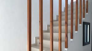 A staircase with wooden handrails and beige steps. - Island-style 3 bedroom house!  (Rethymno)