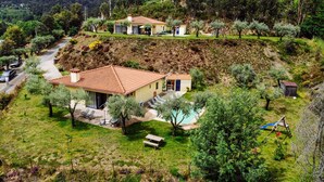 A hillside property with a main house, a smaller structure, and a swimming pool. - Entire house for 5 people, private pool, pets accepted. Fully equipped. (Cabeceira de Basto)