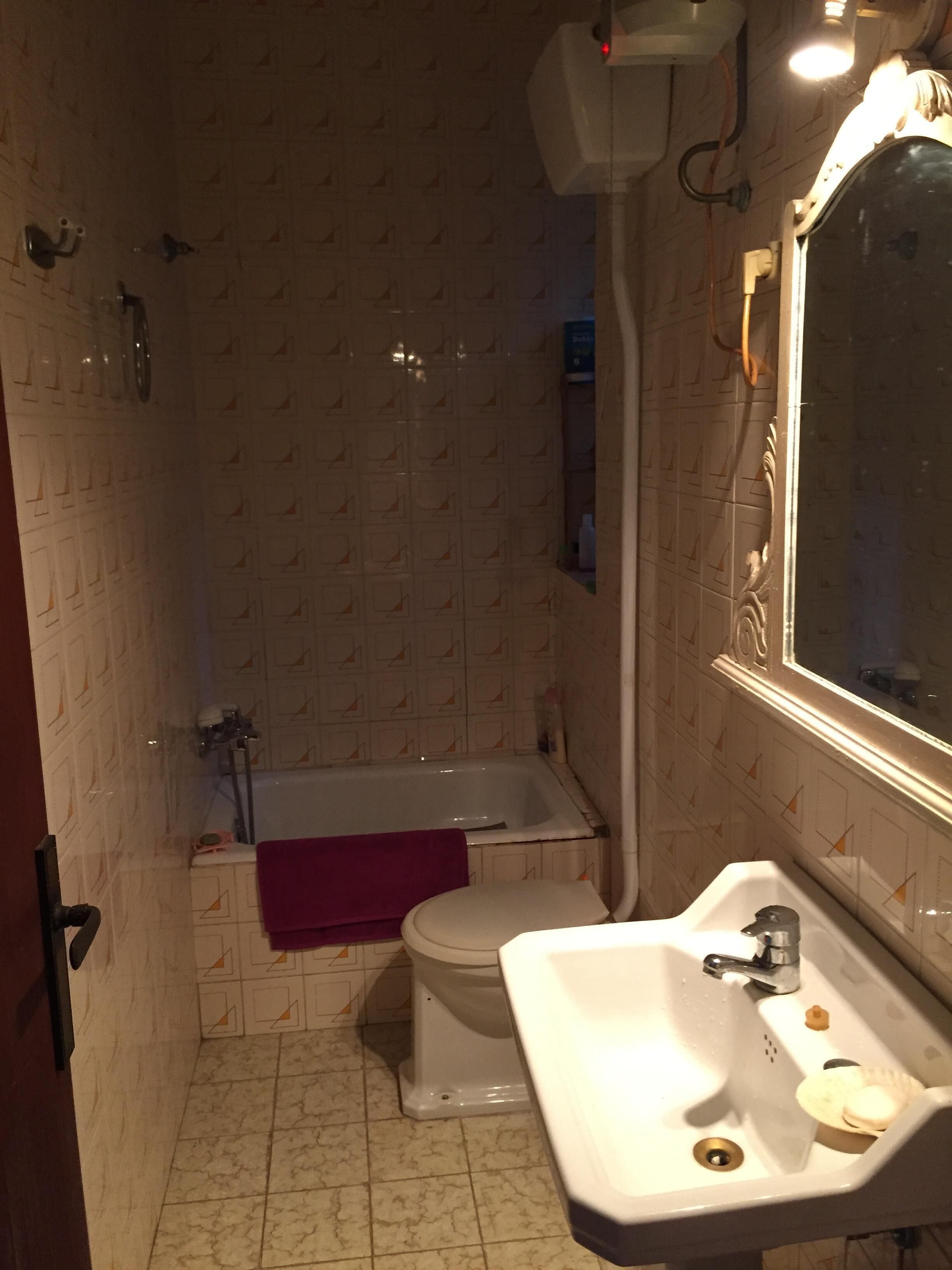 Une salle de bain avec des toilettes, un lavabo et une baignoire.