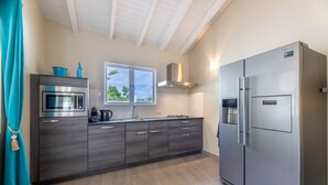 A modern kitchen with a built-in microwave, stove, and refrigerator.