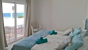 A bedroom with a bed, pillows, and a chair. - DORAMAS APARTMENT, Tias (Puerto del Carmen, Tias)