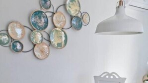 A round glass table with white chairs, a fruit bowl, and a wall-mounted decorative piece. - DORAMAS APARTMENT, Tias (Puerto del Carmen, Tias)
