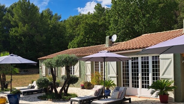 A pool area with lounge chairs and umbrellas, surrounded by a building with a tiled roof and a satellite dish. - fantastically located detached villa with private swimming pool for 8 people. (Callas)