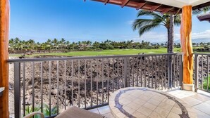 A balcony with a view of a golf course and a rocky landscape. - Includes Mauna Lani Beach Club Pass.  Golf Villa at Mauna Lani D3 (Waimea)