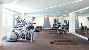 A modern gym with treadmills, weight machines, and free weights. - Cool Place Light Residences (Mandaluyong)