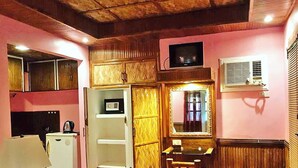 A compact kitchen with a microwave, a refrigerator, a sink, and a wooden cabinet. - Villa Anastacia White Beach Puerto Galera (Puerto Galera)