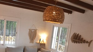 A cozy living room with a sofa, a coffee table, and a hanging light fixture. - House for 6 persons with private pool and large garden in L'Escala (L'Escala)