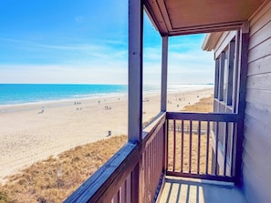 A beach view from a wooden balcony with a railing. - Tilghman Beach and Racquet Club 301 (North Myrtle Beach)