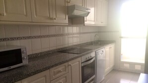 A kitchen with white cabinets, a microwave, a dishwasher, and a window with blinds. - 3 bedrooms and 2 full bathrooms, very comfortable and well equipped. (Denia)