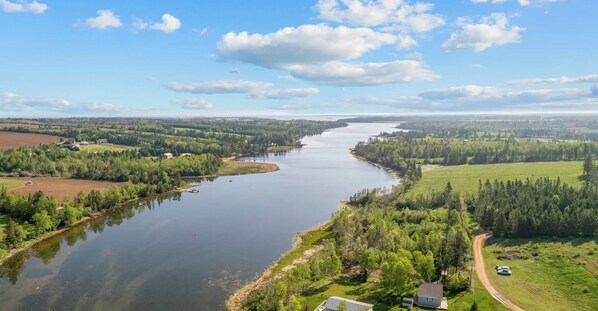 A river winding through a rural landscape with fields and trees, a road, and a small building. - River Front Property With Water View, Minutes To Brackley & Screened In Dining (Oyster Bed)