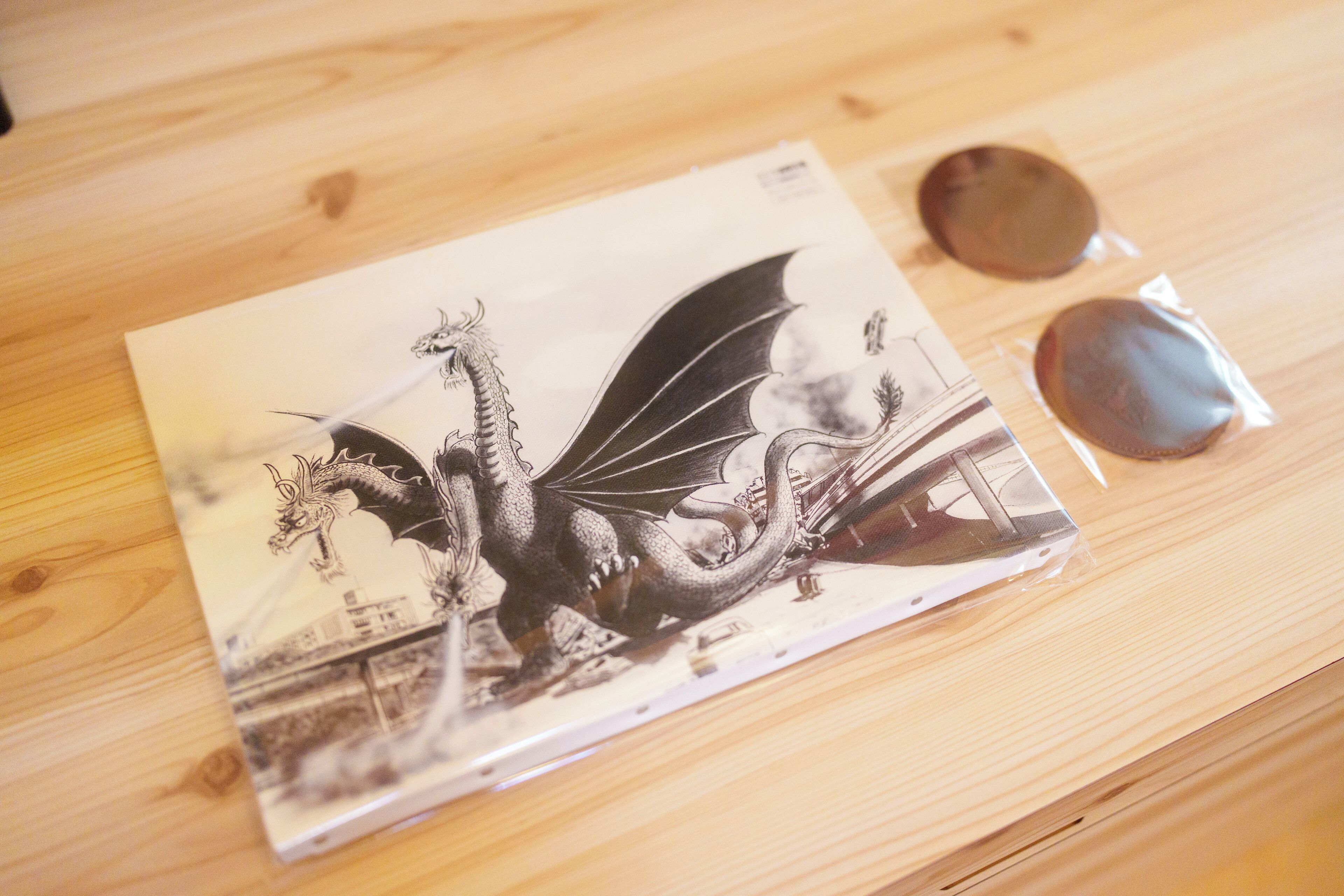 A book with a dragon illustration on a wooden surface.