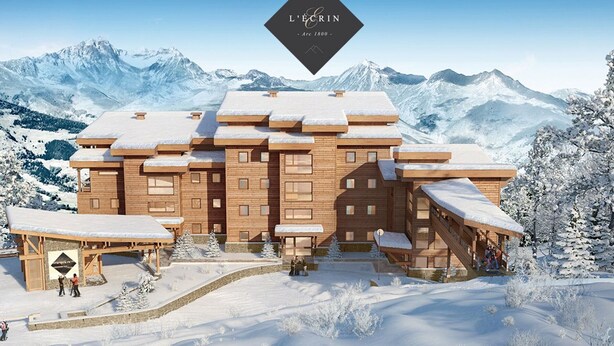 A wooden chalet with multiple balconies and a snow-covered roof, surrounded by snow-covered mountains.