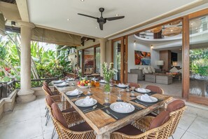 Outdoor dining - Luxury 9-Bedrooms private estate which accomodates up to 27 guests with additional bed arrangements. Jessica Estate includes daily breakfast, a full-time private chef, airport transfers, complimentary massages, housekeeping, and a dedicated driver. (Berawa Canggu)