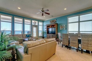 Relax in this inviting living room with a large window, comfortable sofa, and dining area.