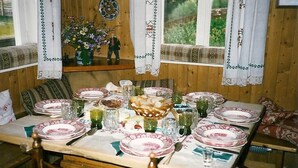 A dining table set with plates, glasses, and a basket of bread. - Apartment "ERHOLUNG" for max. 7 persons (2191170) (St. Veit im Defereggental)