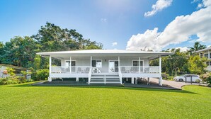 A white two-story house with a covered porch and a small front yard. - Hilo Oasis - 32 Mi to Volcanoes National Park (Hilo)